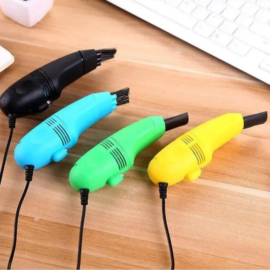 Four colorful handheld vacuum cleaners on a wooden surface.